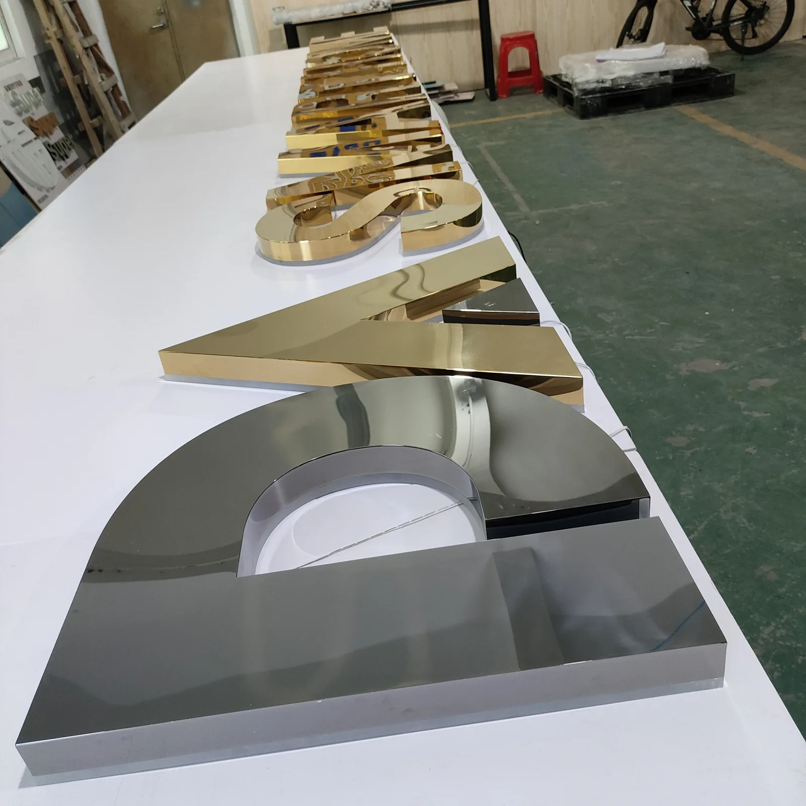 Custom gold storefront letters arranged during production